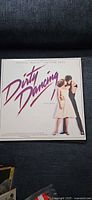 Front cover of Dirty Dancing soundtrack LP displaying title art and actors