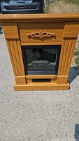 Front view of electric fireplace showing mantel design, firebox, vent
