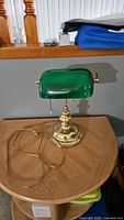 Full view of lamp showing green shade, brass base, and cord