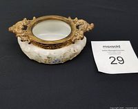 Angled view showing Wavecrest dresser box with gilt brass rim and floral painted opaline glass body