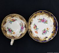 Cup interior and saucer showing cobalt border, gold filigree and floral bouquets
