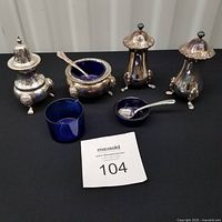 Full lot with all silver pieces, cobalt liners and spoons displayed