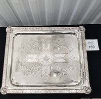 Full view of rectangular silver-plated tray showing etched design and corner figures