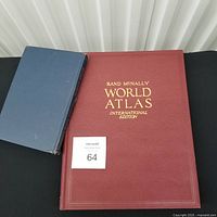 Two atlases side by side: Rand McNally (maroon), Hammond (blue)