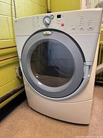 Front and side view of the Whirlpool Duet dryer showing the control panel, door, and front panel.