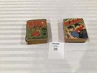 Both Better Little Books side by side with lot number card