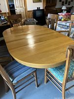 Table extended with leaves and surrounding chairs