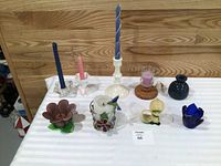 Group shot of nine assorted candle holders and candles