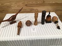 Group shot of all seven wooden folk art pieces on table