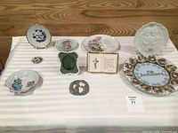 Overview of all ten commemorative plates and keepsakes on table