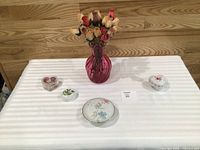 Overall lot showing vase with roses and four trinket pieces on table