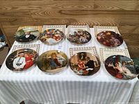 All eight plates, COAs and boxes laid out on table