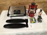 Group shot showing grill with accessories, lantern, oil lamp, novelty toy, metal car