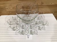 Whole clear glass punch bowl set with cups and ladle displayed
