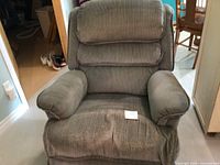 Front view of La-Z-Boy recliner showing overall style and wear on seat and arms