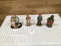 All four porcelain figurines side by side for scale and comparison