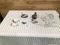 All eight bird figurines displayed on table