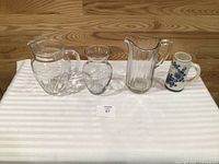 All four items: two pitchers, vase, stein