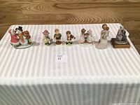 All seven figurines lined up on table