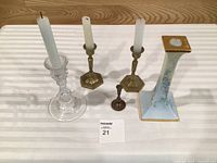 All five candlestick holders and three candles displayed