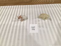 Elephant and bear stone figurines on striped background