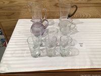 Overall group of four pitchers and six glasses on table