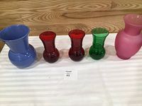 All five colored glass vases lined up