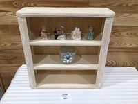 overall view of wicker shelf with figurines and dish displayed