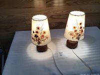 Pair of wooden table lamps on table showing overall design