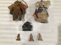 Group shot of all six figurines on striped surface