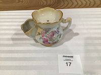 Angled view of ceramic shaving mug showing rose decoration and gold trim