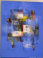 Full view of the blue abstract painting on canvas with multicolored geometric shapes primarily in white, yellow, red, and black.