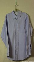 Front view of the Brooks Brothers men's powder blue dress shirt showing classic collar and button front