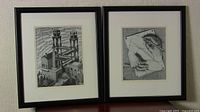 Two framed black and white prints titled "Hands" and "Waterfall", placed side by side, showing overall lot contents.