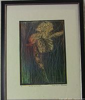 Full view of the framed print showing the iris artwork with black frame and white matting.
