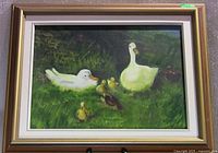 Framed acrylic painting showing entire duck family scene with two adult white ducks and four ducklings on grass with foliage background.