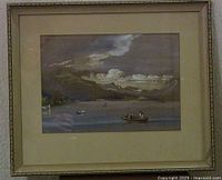 Framed gouache painting of boats on a harbor with mountains and cloudy sky