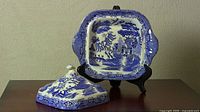 Front view of Blue Willow covered vegetable bowl lid removed and bowl shown on stand.