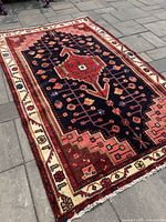 Full view of rug laid out showing overall design and condition