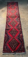 Full view of narrow Hamadan Persian runner rug laid flat