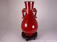 Front view showing vase shape, glaze and both elephant handles