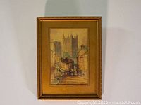 Framed watercolour painting showing a British street scene with Wells Cathedral in the background.