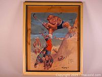 Framed vintage poster showing a caricatured monkey in blue shorts swinging a golf club with two smaller monkeys below and a sandy golf-themed background