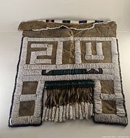 Front view of the Ndebele Mapoto wedding apron showing beadwork and tassels.