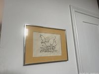 Framed lithograph hanging on wall showing full view