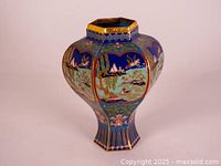 Front and side view of hexagonal cloisonne panel vase showing cobalt blue and gold landscape and bird designs