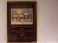 Front view of framed Trisha Romance 1987 exhibition auction poster depicting winter house scene.