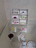 Set of six bone china place card holders in a box, each with different colored floral decorations