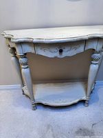 Front and angled view of the light coloured wooden front entry table against wall.