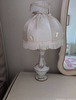Single lamp showing fabric shade and hand-painted floral glass base